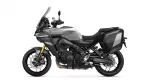 Grey adventure motorcycle shown in side profile with large windshield and grey hard panniers for touring.