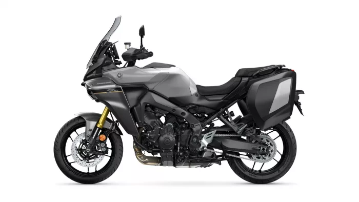 Grey adventure motorcycle shown in side profile with large windshield and grey hard panniers for touring.
