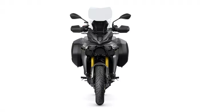 Front view of a gray adventure motorcycle with windshield, side panniers, and gold front forks.
