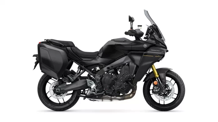 Side view of a black Yamaha Tracer GT adventure motorcycle with hard saddlebags and a tall windshield