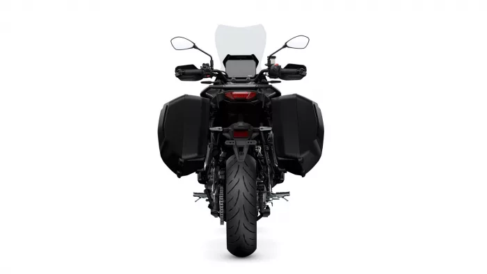 Rear view of a black adventure motorcycle with large side panniers and a tall windscreen