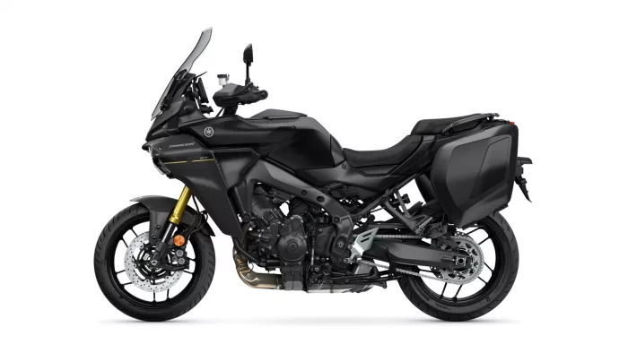 Yamaha Tracer GT sport touring motorcycle with integrated side panniers, shown in profile on black finish and gold front suspension.