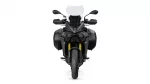 Front view of a dark adventure motorcycle with a tall windshield, dual headlights, and large side panniers on either side of the bike.