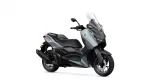 Side view of a silver and black Yamaha scooter with a tall windshield, shown facing right.