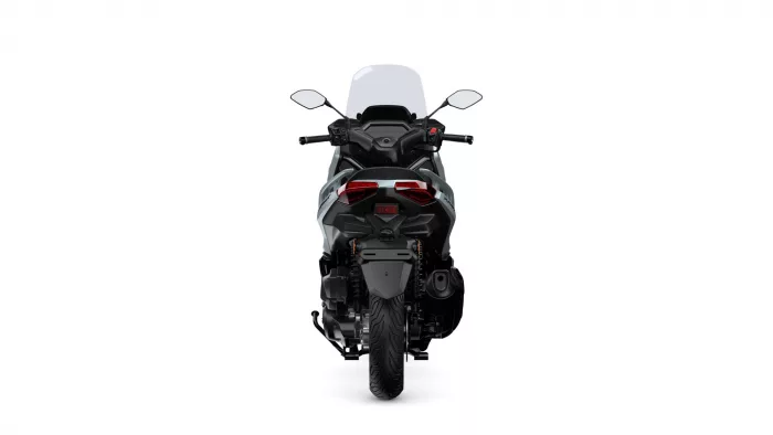 Rear view of a black sport motorcycle with a tall windshield and red taillights against a white background