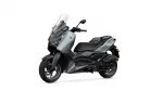 Side view of a gray and black Yamaha XMAX scooter with tall windshield on a white background, showing front/right profile and wheel.