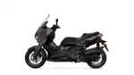 Side view of a dark Yamaha motorcycle with a tall windshield and sporty styling