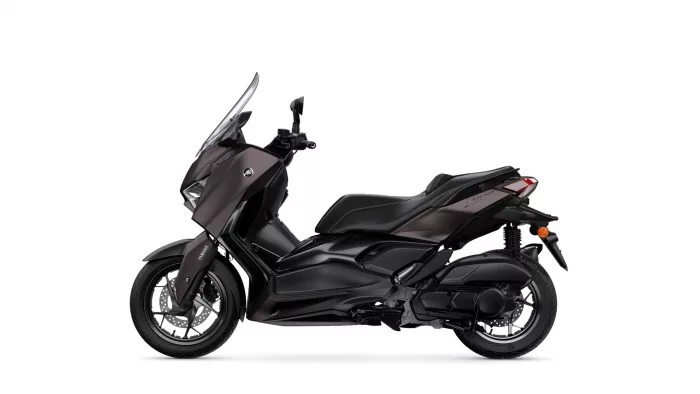 Side view of a dark Yamaha motorcycle with a tall windshield and sporty styling
