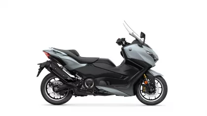 Gray and black sport motorcycle shown in profile view with a tall windshield and exposed front fairing (left-side perspective).