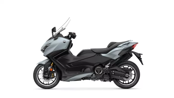 Side view of a silver and black Yamaha sport motorcycle with a windshield and prominent front fairing