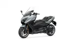 Silver and black Yamaha Tmax sport-tourer motorcycle with a tall windscreen and two-person seat viewed from the front-left side.