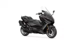 Dark matte Yamaha motorcycle viewed from the side, featuring a sleek windshield and sporty design.