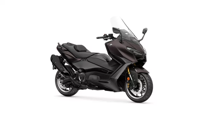 Dark matte Yamaha motorcycle viewed from the side, featuring a sleek windshield and sporty design.