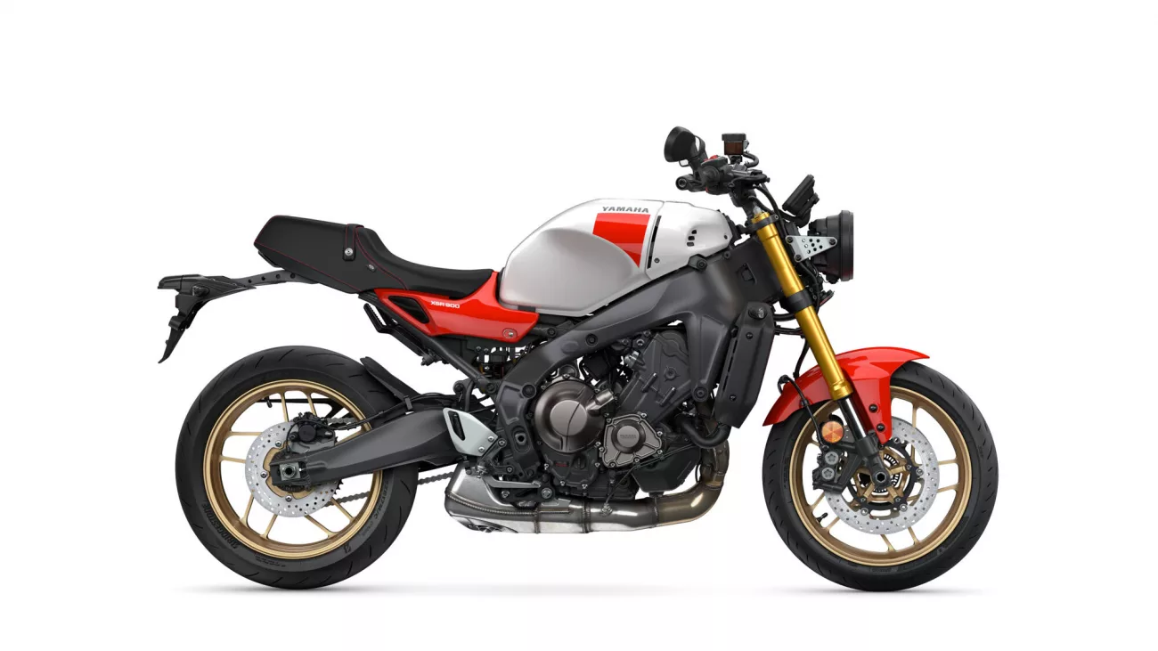 Side-view of a Yamaha sport motorcycle with white fuel tank, red accents, and gold front forks on a white background