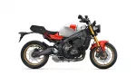 Side-view of a Yamaha sport motorcycle with white fuel tank, red accents, and gold front forks on a white background