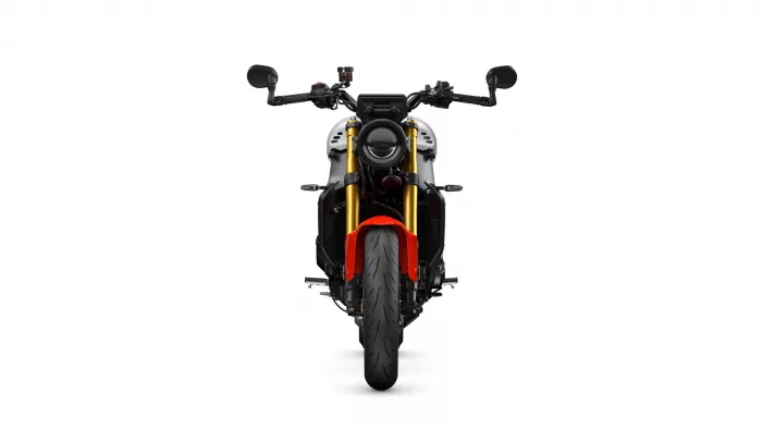 Front view of a modern motorcycle with a round headlight, gold front forks, and red fender.