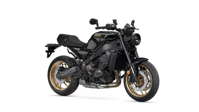 Yamaha XSR900 motorcycle shown from a front-side angle with black body and gold wheels.