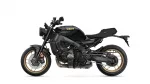 Side view of a black Yamaha motorcycle with gold rims, exposing engine and exhaust (XSR900).