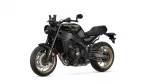 Black Yamaha XSR900 sport motorcycle in a three-quarter front-left view against a white background, showing gold wheels and detailed mechanics.