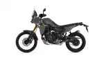Side view of a Yamaha Tenere 700 adventure motorcycle in gray with gold fork, showing off-road tires and front disc brake
