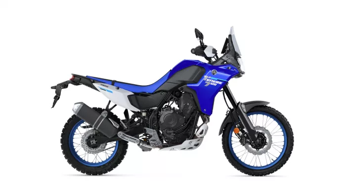 Blue Yamaha Tenere 700 adventure motorcycle shown from the left side, with knobby tires and tall windscreen on white background.