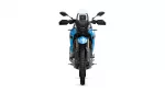 Front view of a blue adventure motorcycle with a tall windshield and knobby tires, facing the camera.