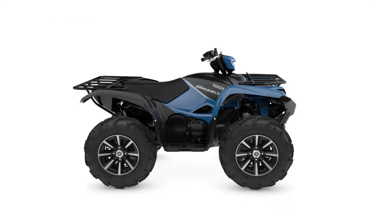 Blue and black Yamaha Grizzly ATV with large off-road tires and front/rear racks, side view