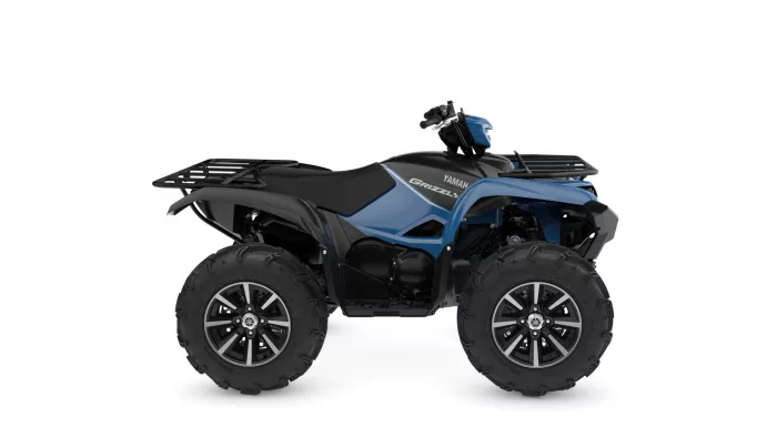 Blue and black Yamaha Grizzly ATV with large off-road tires and front/rear racks, side view