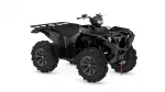 Black quad bike/ATV with large knobby tires, front cargo rack, and red tow strap visible, photographed from a side-angle.