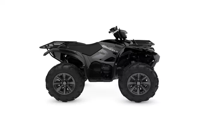 Black Yamaha Grizzly ATV with oversized off-road tires and front/rear cargo racks