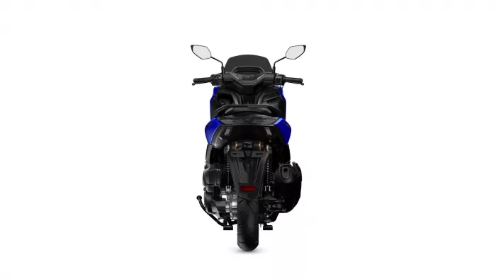 Rear view of a blue sport motorcycle showing the taillight, seat, and wide rear tire from behind.