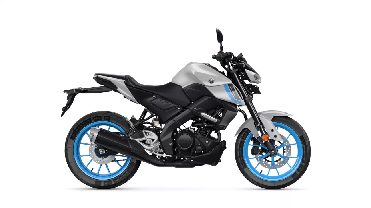 Side view of a silver and black Yamaha motorcycle with bright blue rims and exposed engine components.