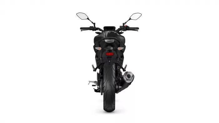 Rear view of a black sport motorcycle on a white background, showing taillight and exhaust.