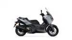 Side view of a gray Yamaha XMAX scooter with windshield and black chassis.