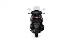 Rear view of a black/silver sport motorcycle with a tall windshield, red taillights, and a wide rear tire.