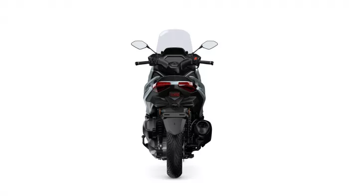 Rear view of a black/silver sport motorcycle with a tall windshield, red taillights, and a wide rear tire.