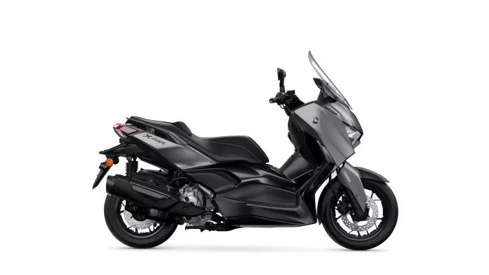 Side view of a black Yamaha X-MAX scooter with a tall windshield on a white background.