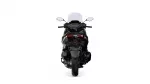 Rear view of a black sport motorcycle with a tall windshield and red taillights seen from behind on a white background