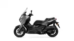 Side view of a gray and black Yamaha Tmax sport-tourer motorcycle, showing its sleek fairing and windshield