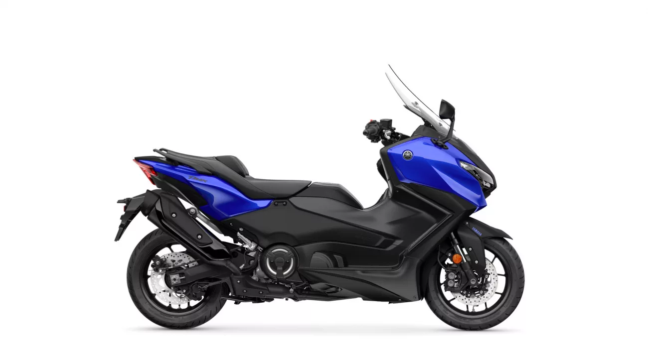 Side view of a blue and black Yamaha sport motorcycle with a tall windshield sun visor on a white background