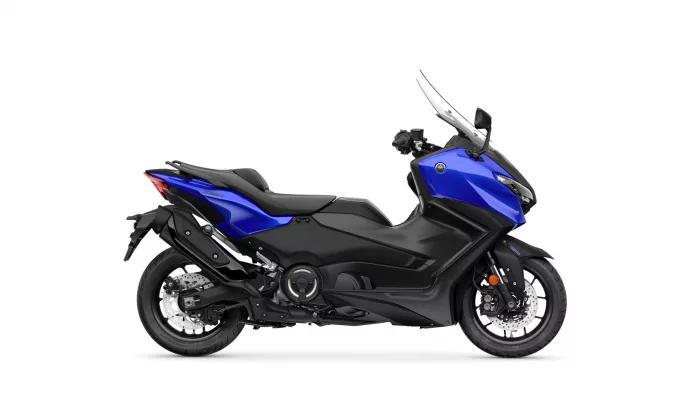 Side view of a blue and black Yamaha sport motorcycle with a tall windshield sun visor on a white background