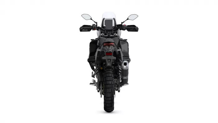 Rear view of a black adventure motorcycle, showing the wide rear tire, taillight, and exhaust.