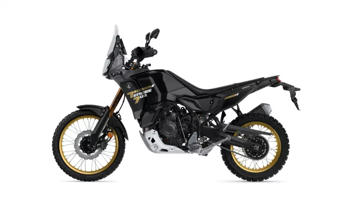Side view of a black Yamaha Tenere 700 World Raid adventure motorcycle with gold rims and windshield against a white background.