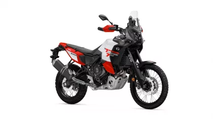 Yamaha Tenere 700 World Raid adventure motorcycle, red/white/black, shown from a front-side angle with tall windshield and off-road tires