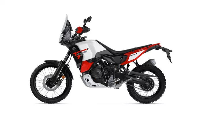 Side view of a white and red Yamaha Tenere 700 World Raid adventure motorcycle with tall windscreen.