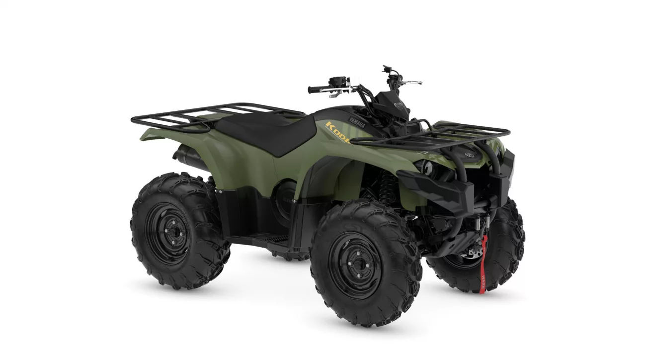 Green Yamaha ATV (Kodiak) with front and rear cargo racks and large off-road tires, angled view
