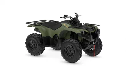 Green Yamaha ATV (Kodiak) with front and rear cargo racks and large off-road tires, angled view
