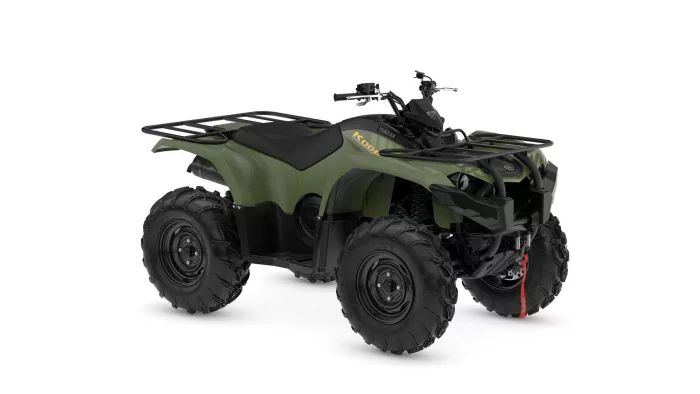Green Yamaha ATV (Kodiak) with front and rear cargo racks and large off-road tires, angled view