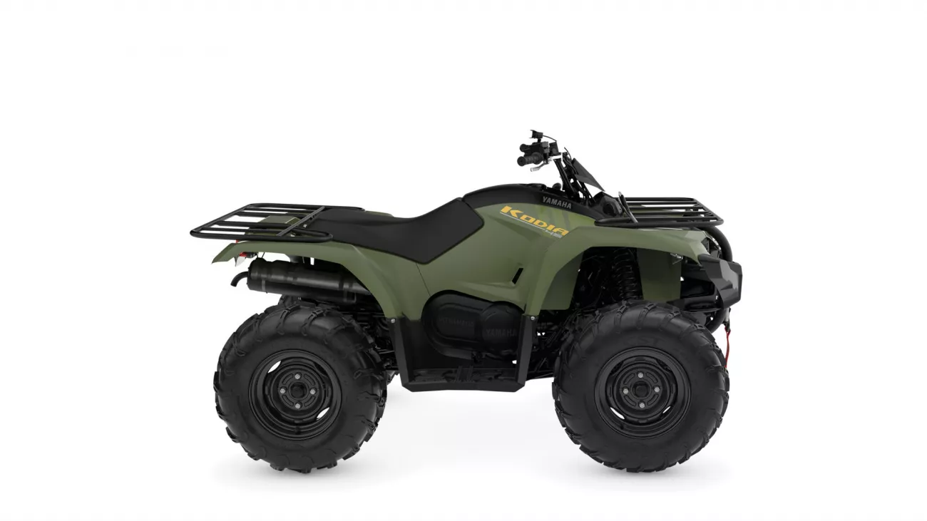 Olive green Yamaha ATV with front and rear cargo racks, large off-road tires, and black seat. Alternative 1