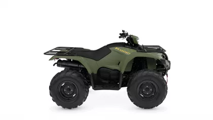 Green Yamaha Kodiak all-terrain vehicle with front and rear cargo racks and large off-road tires shown in a three-quarter view.